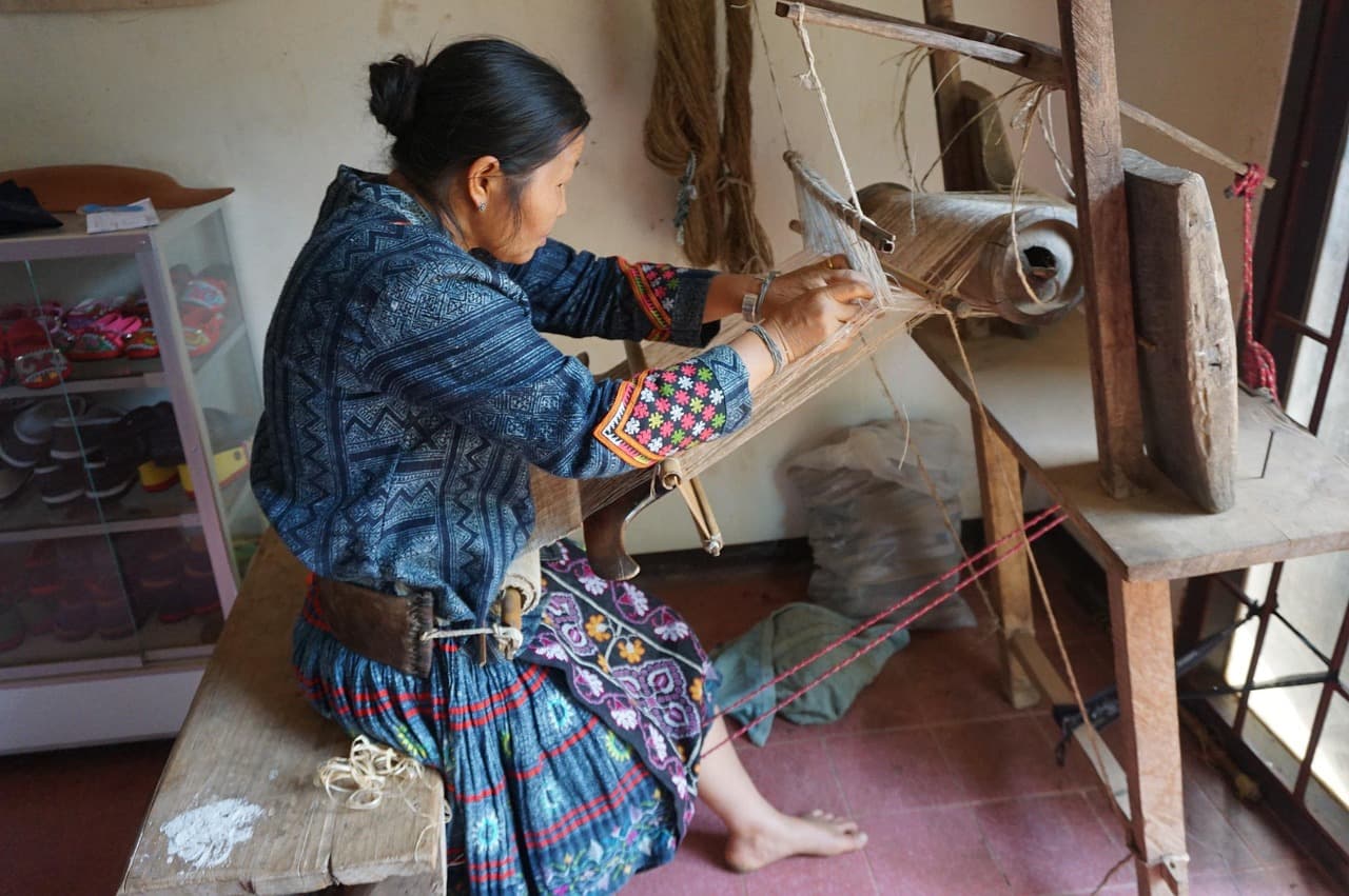 Hmong weaver at a wooden loom in Northern Thailand